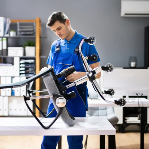 image of a person checking an office chair for broken parts - can office chair be repaired