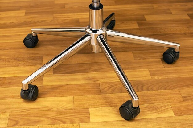 office chair with aluminum base and casters on a wood floor