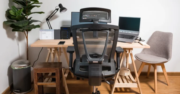 An ergonomic workspace setup featuring a modern ergonomic chair with a headrest, surrounded by a tidy desk, dual monitors, and natural lighting. Learn what does ergonomic chair mean for your comfort and health