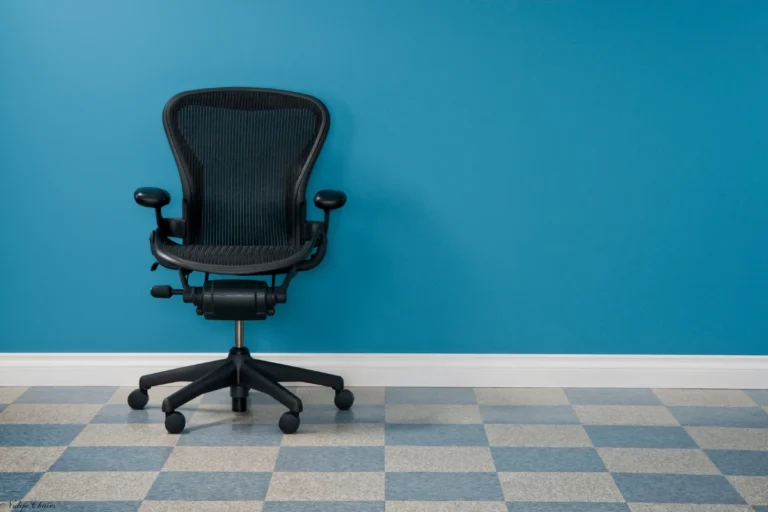 image of used herman miller aeron chair with blue background - what does fully loaded mean