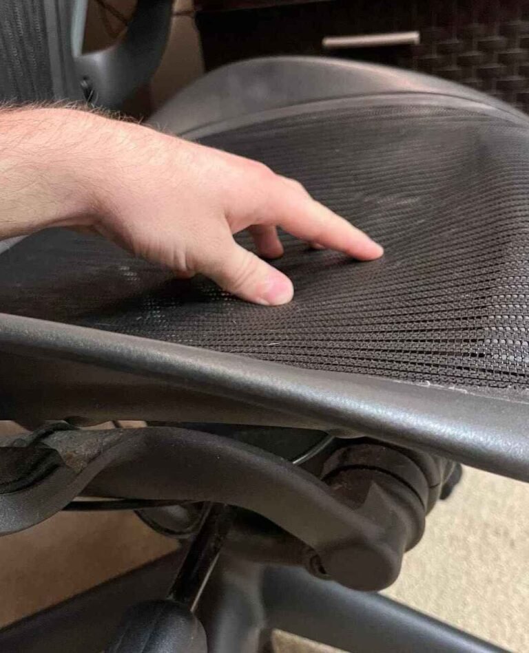 Office chair with sagging mesh or worn upholstery indicating need for repair or replacement